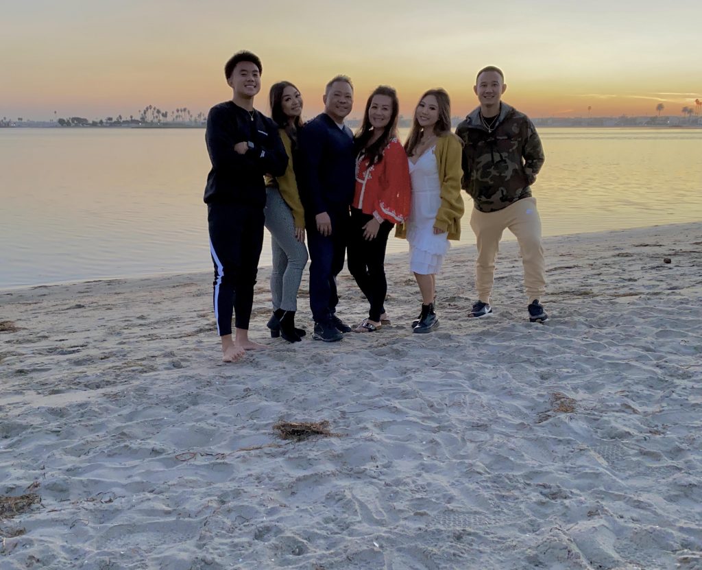 Tracie Noriega and her family on the beach at sunset